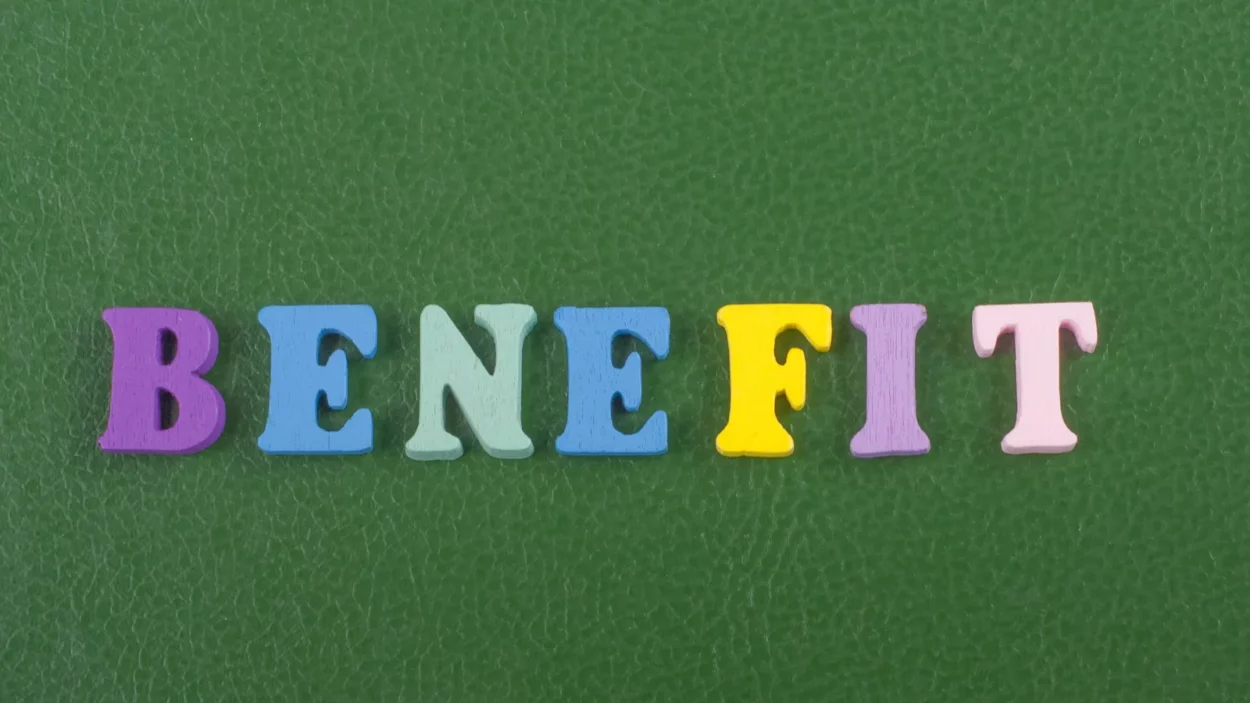 Benefit word on green background composed from colorful abc alphabet block.