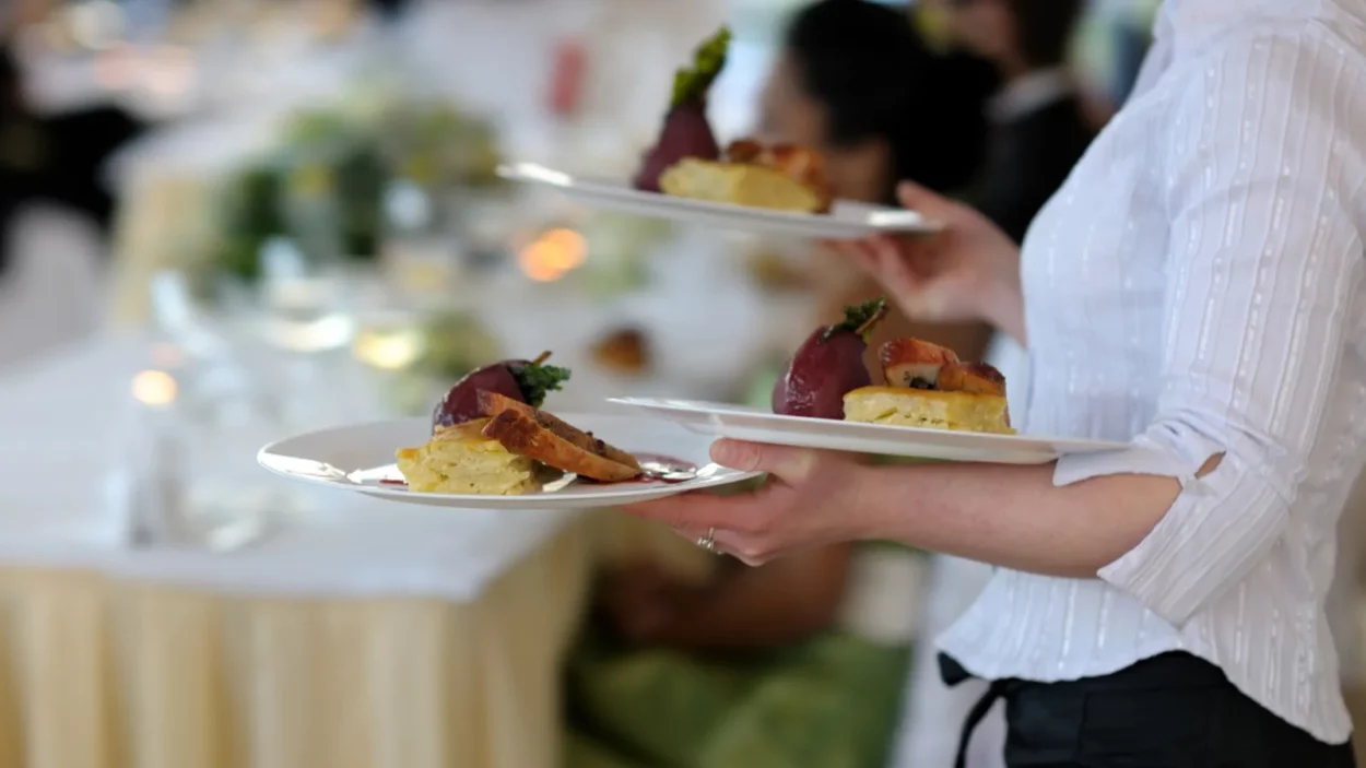 waitress carrying three plates