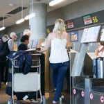 Travelers checking in for flights at the departure terminal of Valencia Airport in Spain.