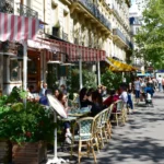 Parisian cafes with terraces and people.